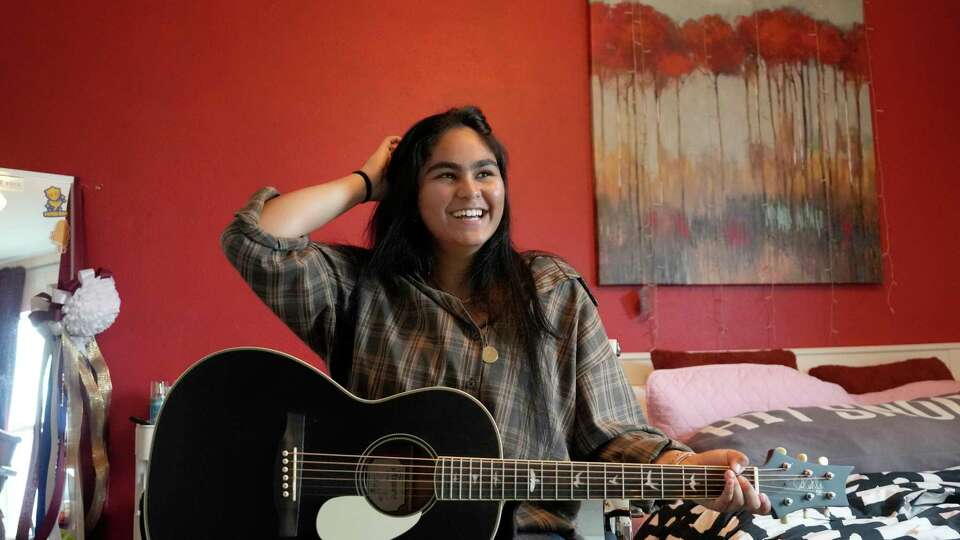 Maisa Ahmad, a senior Klein Collins HS, plays guitar at her home Thursday, May 9, 2024, in Spring. She is headed to Bard College in the fall and wants to become a lawyer.