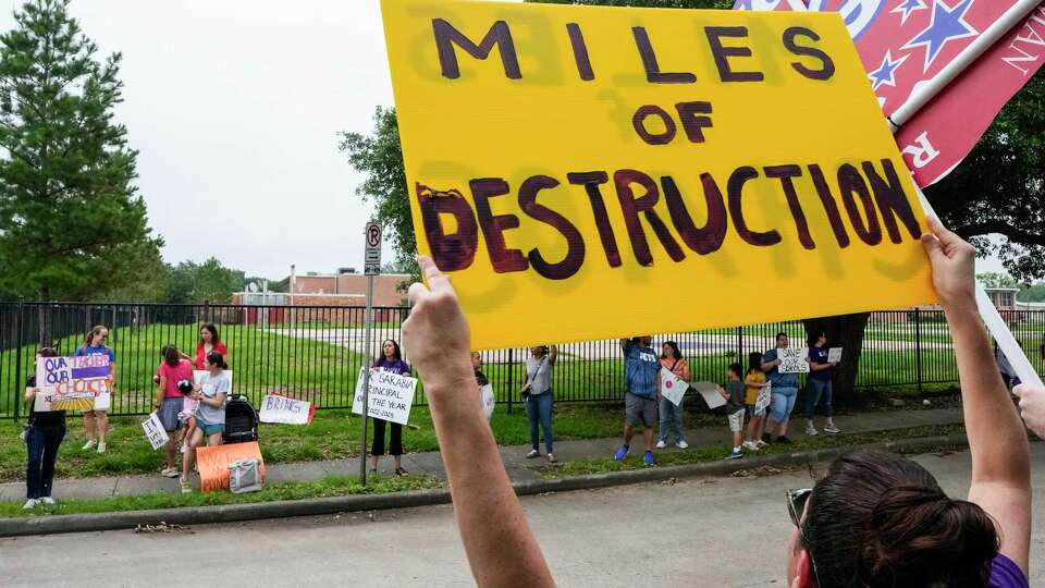 Meyerland Performing and Visual Arts Middle School parents and students demonstrate against the resignation notice of Principal Auden Sarabia on Monday, May 13, 2024 in Houston. Sarabia told staff he must either resign by Tuesday or go before the district's Board of Managers.