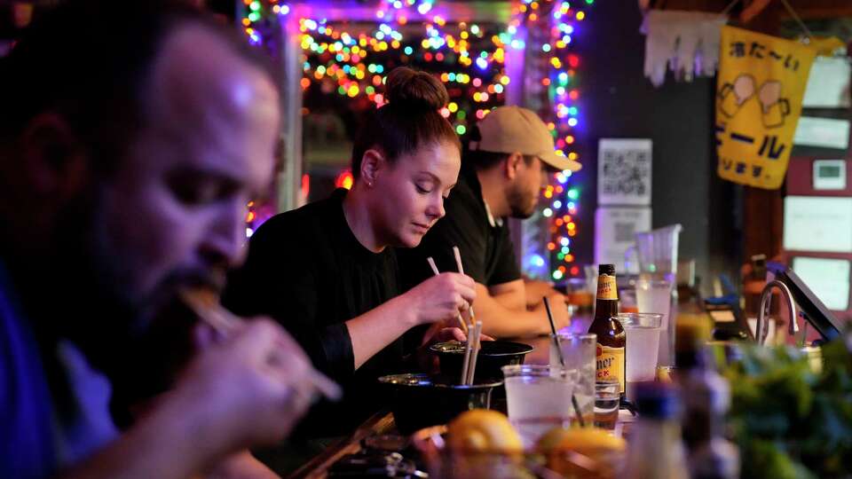 People dining and drinking at Ninja Ramen Friday, April 19, 2024 in Houston. Ninja Ramen has been open for 10 years but business has been difficult this past year.