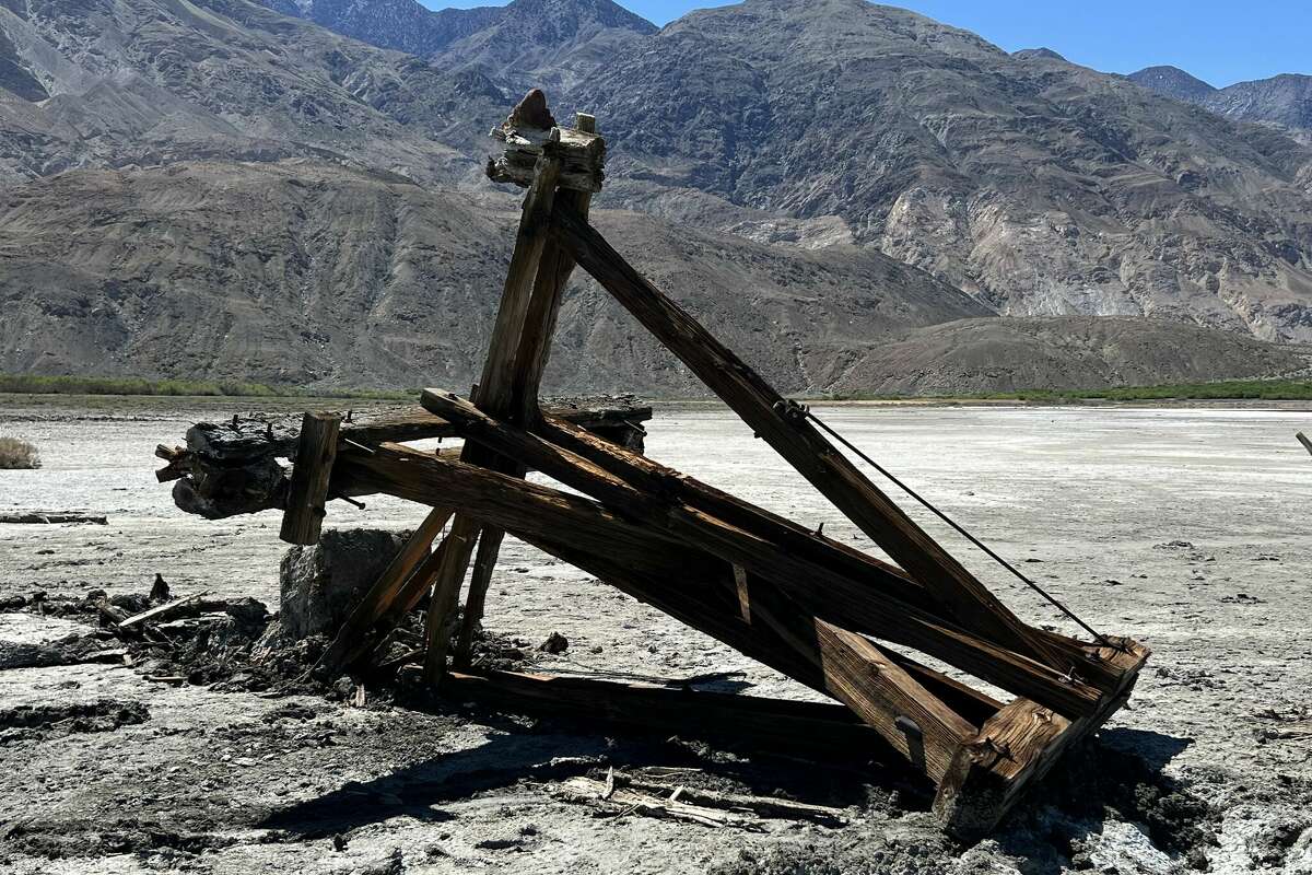 A driver toppled a 113-year-old tram tower, seen above, in Death Valley while trying to get their vehicle unstuck from a patch of mud, the National Park Service said. 