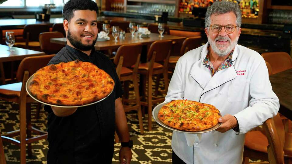 Chef Jay Forrest, left, and his grandfather, Jonathan Levine, executive chef and owner, pose for a portrait at the newest location of Jonathan's The Rub in the East End on Tuesday, May 14, 2024 in Houston. Jonathan's the Rub is opening in 2900 block of Navigation, the restaurant's third location. The eatery is introducing pizza at this location, partly because, Levine, its founder is a native New Yorker.