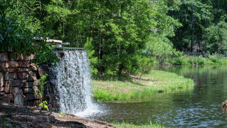 The pond and waterfall at Mystic Lake Park are visible and provide fishing opportunities along Cochrans Crossing Dr. near Research Forest Dr. in the Woodlands.