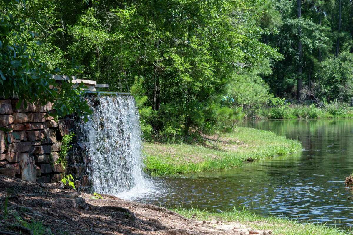 The pond and waterfall at Mystic Lake Park are visible and provide fishing opportunities along Cochrans Crossing Dr. near Research Forest Dr. in the Woodlands.