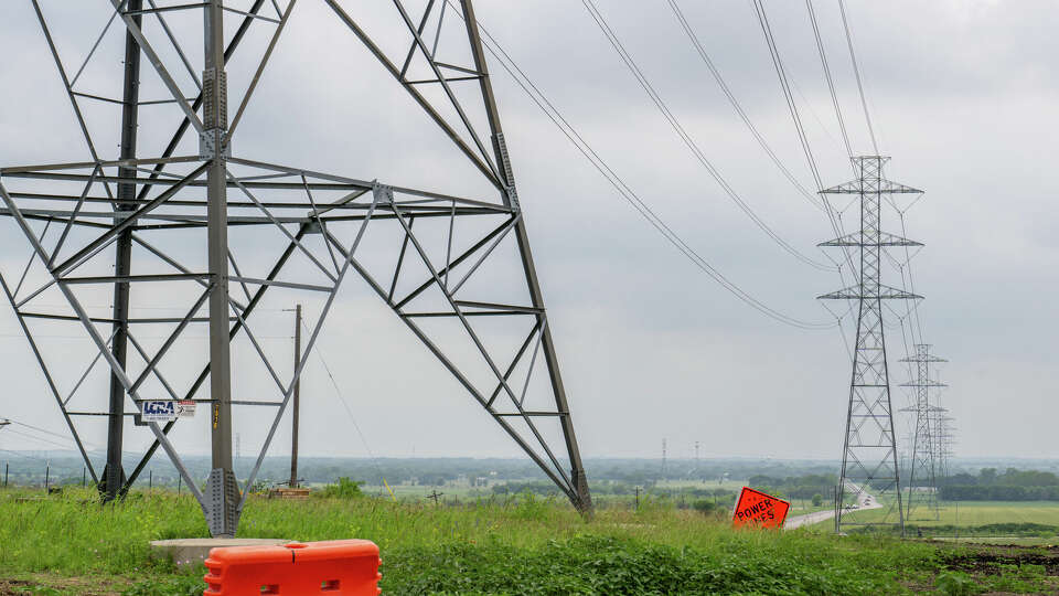 A general view of a transmission towers in a field on April 17, 2024 in San Marcos, Texas. The Electric Reliability Council of Texas (ERCOT) have asked power generating companies to postpone scheduled maintenance to help alleviate potential setbacks as temperatures have risen to the mid 80s. Rising temperatures has the potential to lead to an increased power demand during scheduled maintenance times, creating a power emergency.