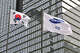 Article Image A South Korean national flag (L) and a Samsung flag (R) flutter outside the company's Seocho building in Seoul on April 30, 2024. Samsung Electronics said on April 30 that its first-quarter operating profits had risen nearly tenfold year-on-year -- a 931.8 percent increase -- amid recovering chip prices and growing demand.