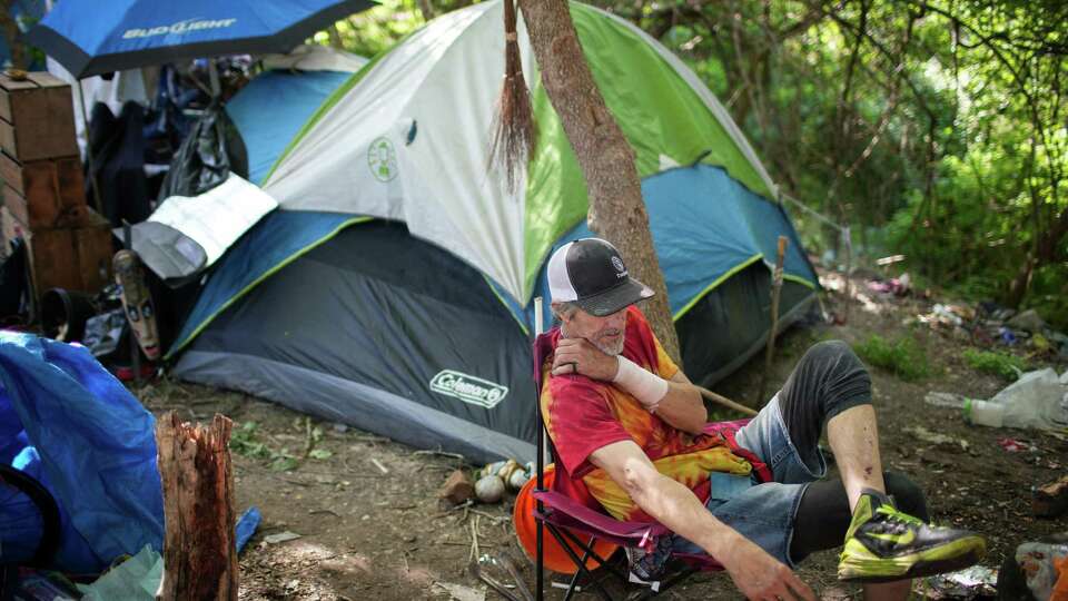 A man who goes by Shaggy talks about the high number of tickets he has received from police Tuesday, March 26, 2024, at a homeless encampment in Houston.