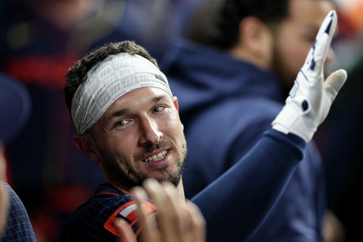 Alex Bregman #2 of the Houston Astros reacts in the dugout after a home run in the seventh inning against the Oakland Athletics at Minute Maid Park on May 13, 2024 in Houston, Texas.