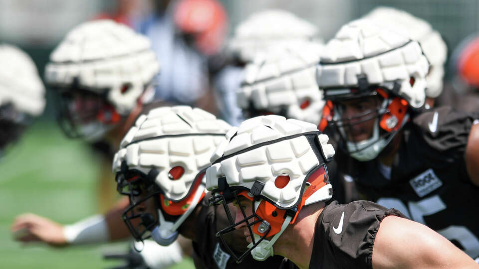 Cleveland Browns players take part in drills while wearing Guardian Caps during the NFL football team's training camp, Thursday, July 28, 2022, in Berea, Ohio. (AP Photo/Nick Cammett)