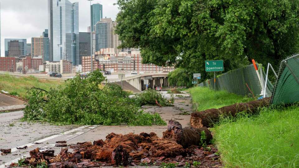 Debris fills the feeder road near Interstate 10 and Interstate 45 near downtown Houston after severe storms pass through the area Thursday, May 16, 2024