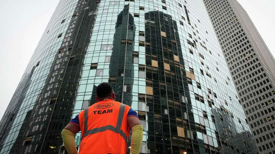 A man surveys damage from a storm Friday, May 17, 2024, in downtown Houston.