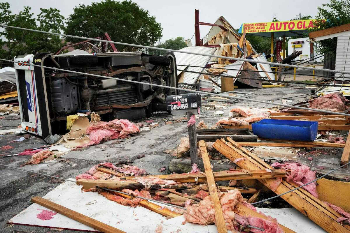 A US Postal Service truck is flipped on its side at the intersection of Bingle and Sowden in the aftermath of a severe storm on Friday, May 17, 2024 in Houston. Fast-moving thunderstorms pummeled southeastern Texas for the second time this month, killing at least four people, blowing out windows in high-rise buildings, downing trees and knocking out power to more than 900,000 homes and businesses in the Houston area.