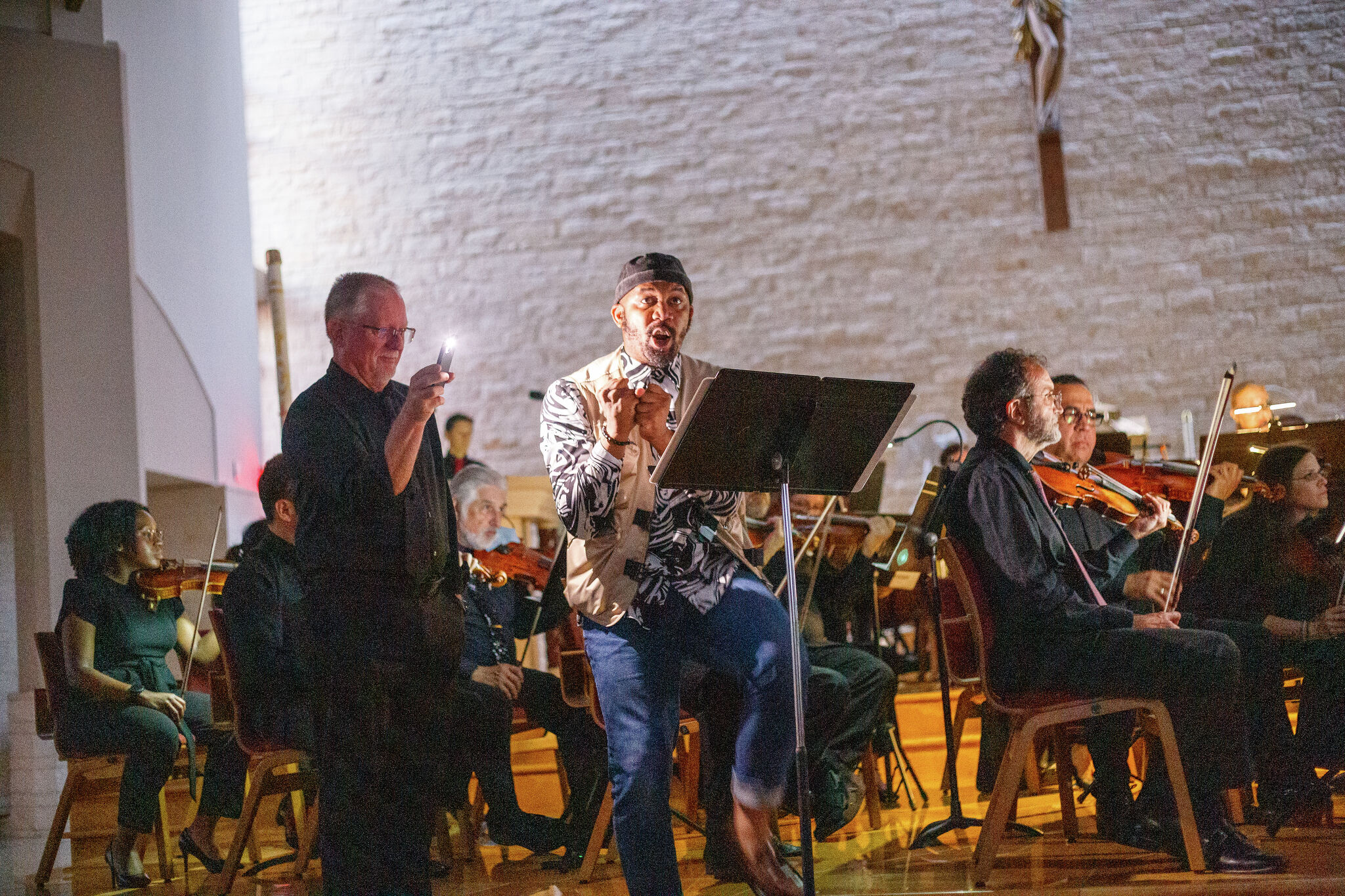 Houston orchestra performs by cellphone light after extreme storm