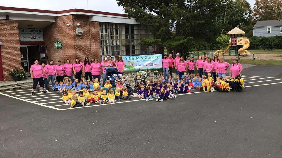 Teachers, directors and children pose in front of A Child's Garden to celebrate its 40th anniversay in October 2021 at 100 Mona Terrace in Fairfield, Conn.