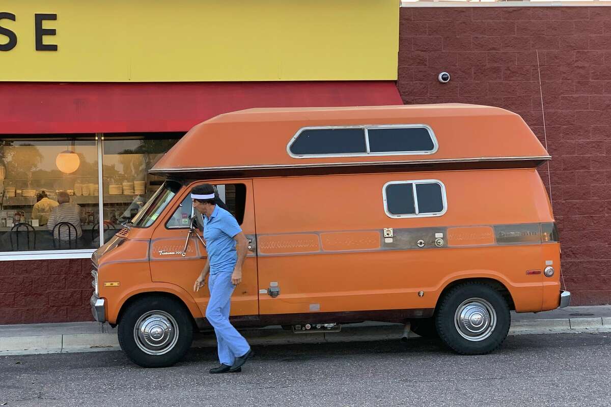 Uncle Rico's van, plus Napoleon Dynamite actor Jonathan Gries, in front of a Waffle House during a 2019 ESPN short film shoot. 