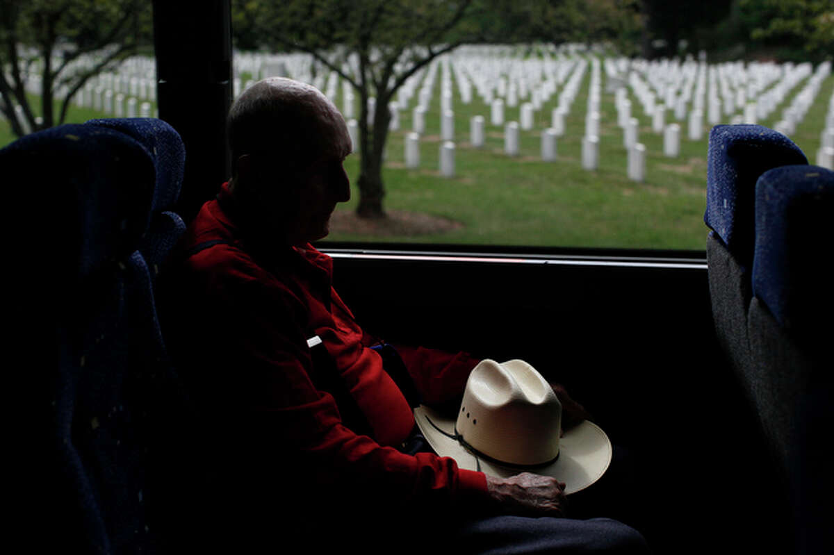 Charlie Moore, 92, one of the 30 veterans on the first Alamo Honor Flight, waits to leave Arlington National Cemetery after the group watched the Changing of the Guard at the Tomb of the Unknowns and after four San Antonio veterans participated in a wreath ceremony at the tomb. The following day at San Antonio International Airport they were greeted by hundreds of military troops and civilians, completing the first tour organized by Alamo Honor Flight. Some travelers and others were in tears at seeing the veterans, ranging in age from 82 to 93, return to military salutes and applause of flag-waving supporters.