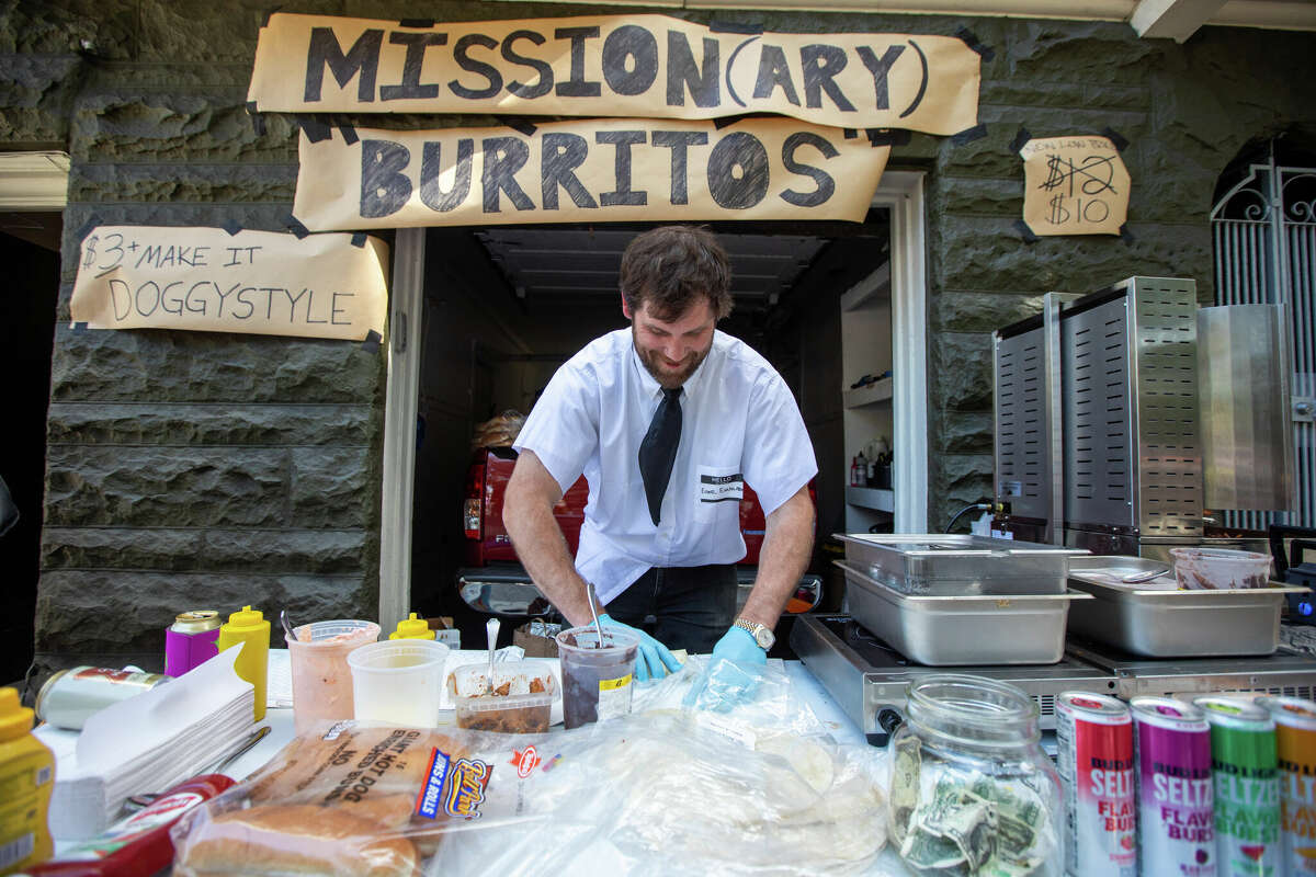 Jeff Kinnunen makes burritos on the Bay to Breakers route in San Francisco on May 19, 2024.