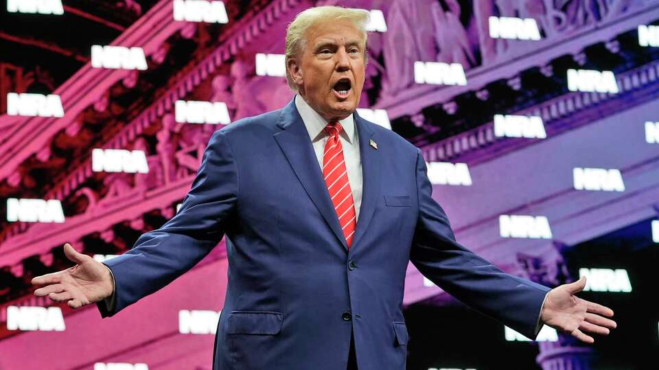 Former President Donald Trump gestures as he is applauded before speaking at the National Rifle Association Convention, Saturday, May 18, 2024, in Dallas. (AP Photo/LM Otero)