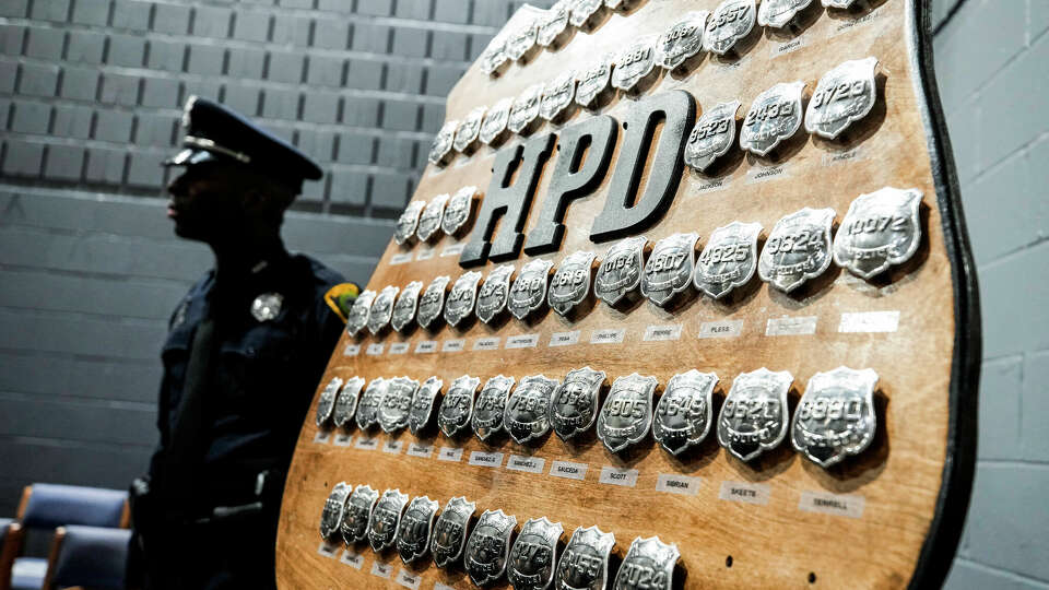 Cadets badges are posted on a board before being presented during a Houston Police Academy graduation ceremony in January 2023.