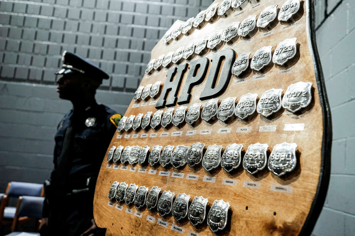 Cadets badges are posted on a board before being presented during a Houston Police Academy graduation ceremony in January 2023.