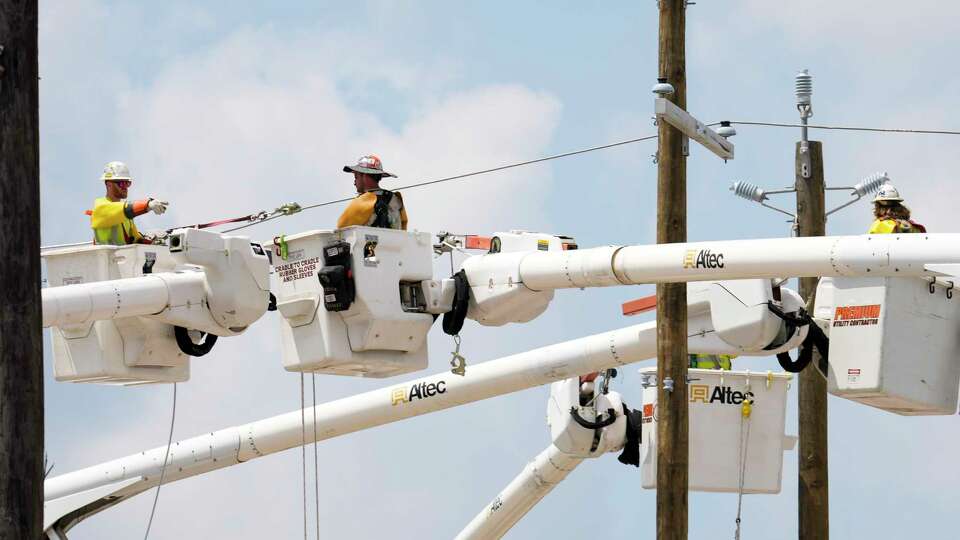 Workers restoring power lines at Hempstead Highway and Bingle Road in Spring Branch neighborhood Monday, May 20, 2024 in Houston.