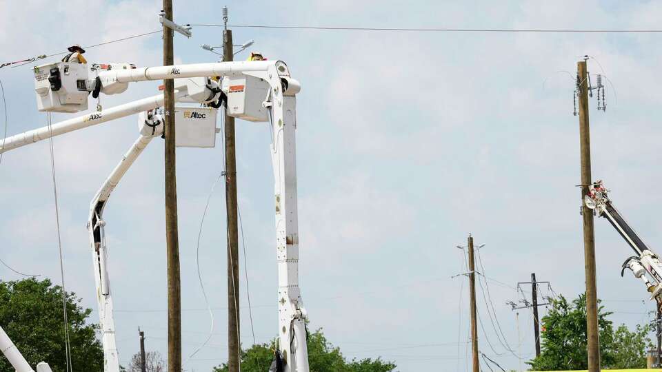 Workers restoring power lines at Hempstead Highway and Bingle Road in Spring Branch neighborhood Monday, May 20, 2024 in Houston.