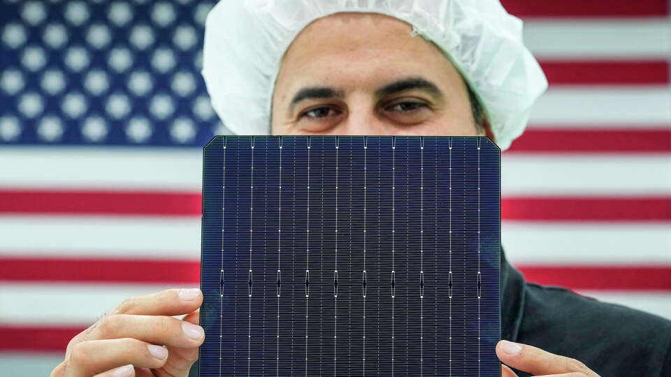 Ali Sivritepe, maintenance manager, shows a photovoltaic cell at Elin Energy's solar panel manufacturing facility in Brookshire, Texas. Nearly nine in 10 Houstonians surveyed by the Rice University Kinder Institute for Urban Research said the region should lead the world's energy transition.