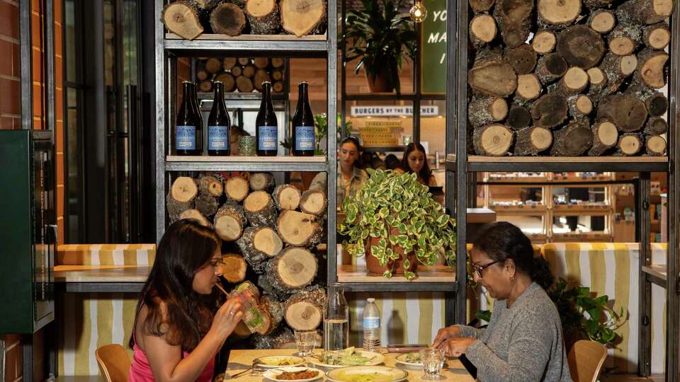 Simi Roy, left, and Aruna Roy, eat at the Fife & Farro, a pizza and pasta restaurant in Pullman Market at Pearl, on Thursday, May 9, 2024 in San Antonio. Emmer & Rye Hospitality Group opened and operates Pullman Market, which recently opened at Pearl.