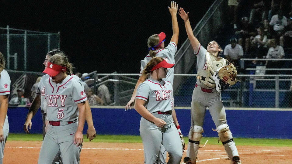 Katy's Maddie Smith (3) high-fives Montgomery Henderson (17) after Katy beat Cinco Ranch to win 8-0 during Region III-6A softball quarterfinals at Tompkins High School on Thursday, May 9, 2024, in Katy.