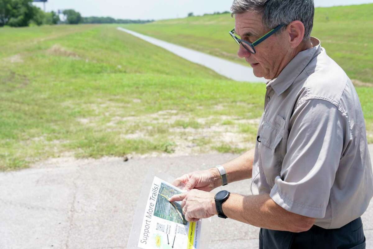 Cycling enthusiast Byan Dotson discusses a proposal, Monday, May 20, 2024, to use a strip of federal land along George Bush Park at Barker Reservoir from Noble Road to Piping Rock Lane to connect existing bike trails to the north and west with trails to the south and east including existing and proposed trails through the medical center to downtown creating a 55 mile long system of dedicated bike trails throughout the Houston area.