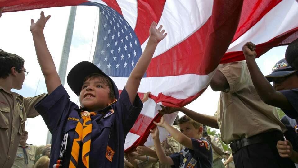 Antonio Ruiz, 7, of Spring with Cub Scouts Pack 355, among scouts as they raise a U.S. garrison flag at the Houston National Cemetery,10410 Veterans Memorial Drive, Sunday, May 29, 2011, in Houston. After the garrison flag raising ceremony the scouts took part in the raising of 300 U.S. flags measuring 5 foot by 10 foot along the cemetery roadways as part of the Avenue of Flags. Scout units both boys and girls took part in this preparation for the Memorial Day Ceremony, to be held at the national cemetery on Monday, May 30, at 9:30 a.m. ( Melissa Phillip / Houston Chronicle )