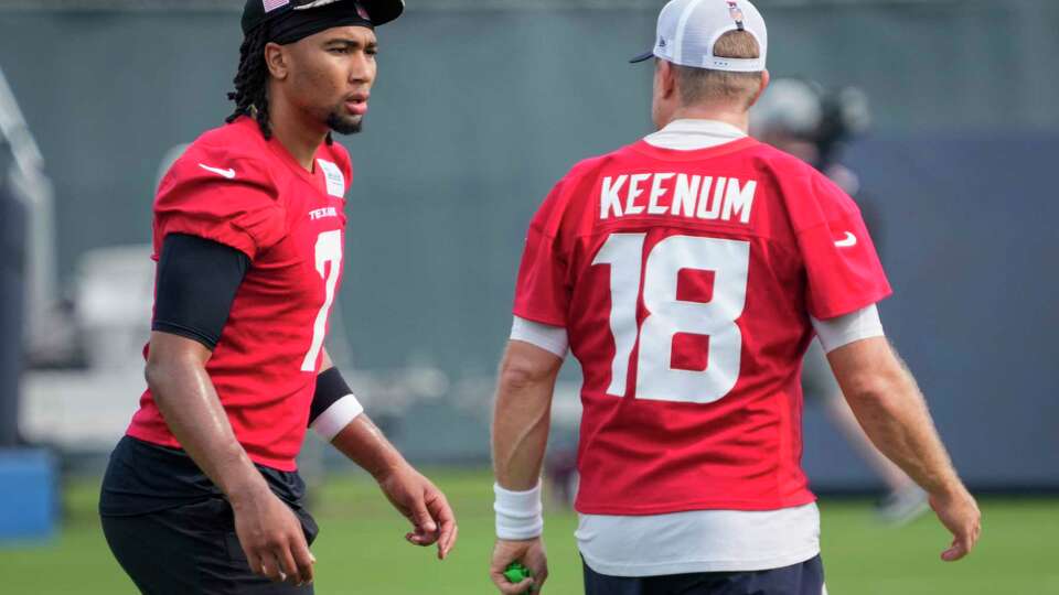 Houston Texans quarterback C.J. Stroud (7) talks to Case Keenum (18) as they warm up during an NFL football OTA practice on Tuesday, May 21, 2024, at Houston Methodist Training Center in Houston.