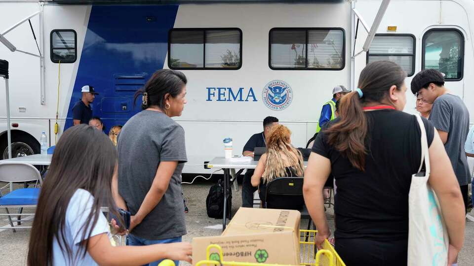 People affected by the recent severe storms waiting in line at FEMA mobile unit to get assistance Tuesday, May 21, 2024 at Spring Branch Family Development Center in Houston.