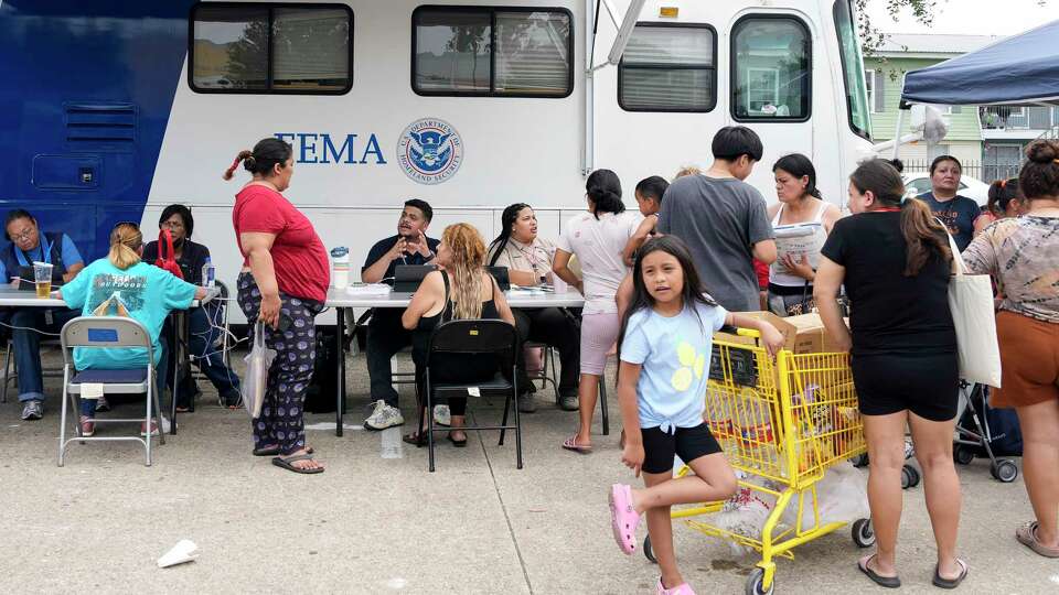 People affected by the recent severe storms waiting in line at FEMA mobile unit to get assistance Tuesday, May 21, 2024 at Spring Branch Family Development Center in Houston.