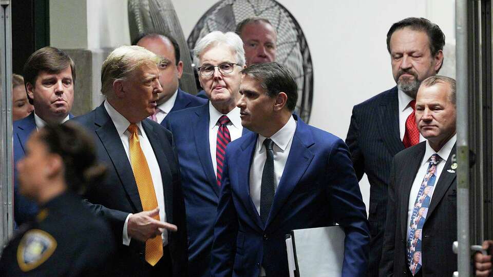 Former President Donald Trump speaks with his attorney Todd Blanche during in his trial, Tuesday, May 21, 2024, in Manhattan Criminal Court in New York. Looking on, from left are. U.S. Rep. Dale Strong, R-Ala. Texas Lt. Gov. Dan Patrick, radio host Sebastian Gorka and U.S. Rep. Troy Nehls, R-Texas. (Curtis Means/Dailymail.com via AP, Pool)