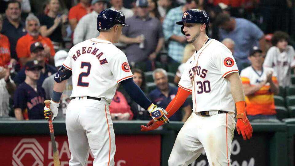 Houston Astros Kyle Tucker (30) celebrates his home run with Alex Bregman (2) during the seventh inning of an MLB baseball game at Minute Maid Park on Wednesday, May 22, 2024, in Houston.