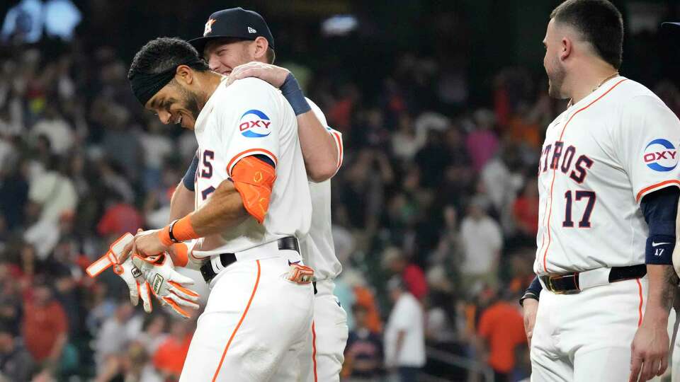 Houston Astros Jeremy Peña (3) celebrates Grae Kessinger after walking it off with a single during the tenth inning of an MLB baseball game at Minute Maid Park on Wednesday, May 22, 2024, in Houston.