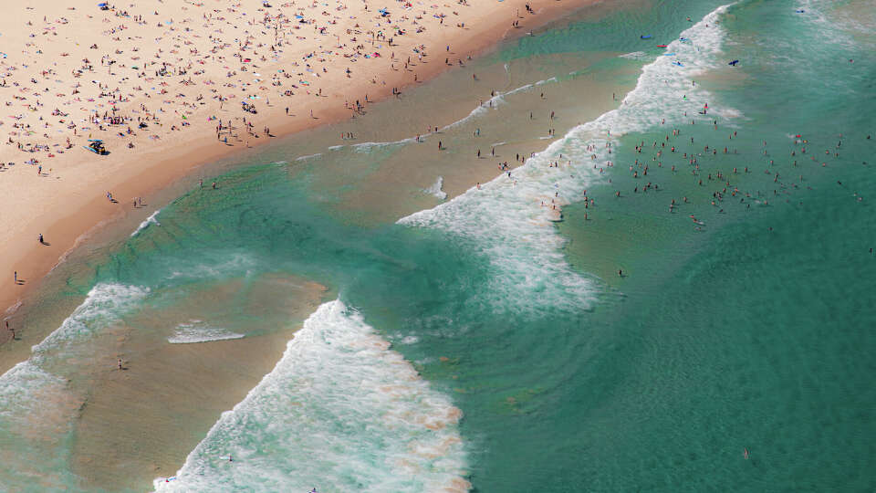 water at Bondi Beach Sydney Australia looking dramatic at low tide with water swirling as swimmers and surfers enjoy summer day weather