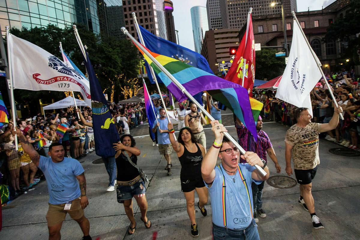 Parade participants wave flags as they march in the annual Pride Parade on Saturday, June 24, 2017, in Houston. ( Brett Coomer / Houston Chronicle ) (Photo by Brett Comer/Houston Chronicle via Getty Images)