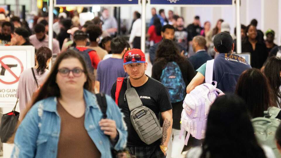 People head toward baggage claim as people travel through Bush intercontinental Airport ahead of the Memorial Day weekend, Wednesday, May 22, 2024, in Houston.