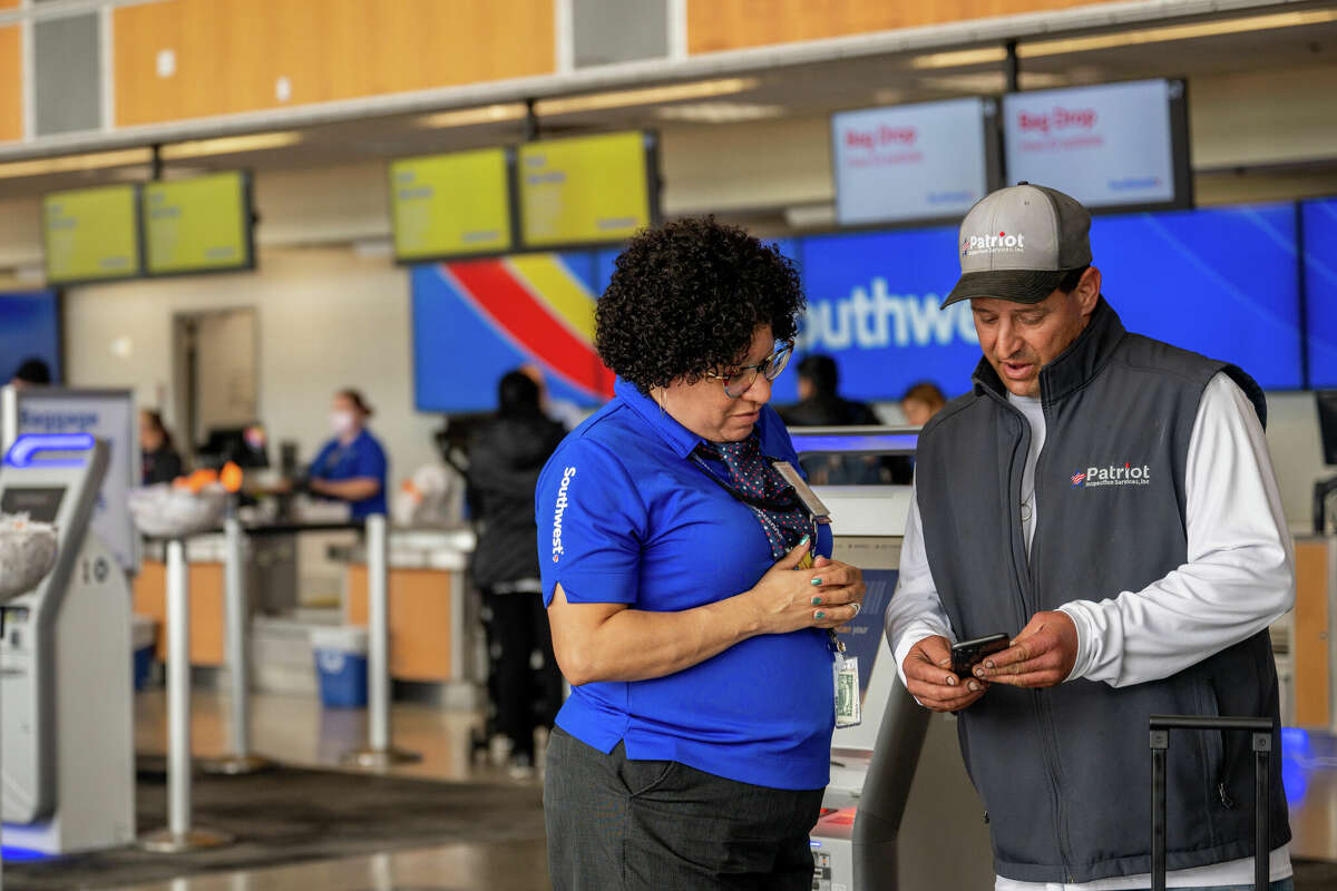 A Southwest Airlines employee assists a passenger during their check-in at the Austin-Bergstrom International Airport on April 18, 2023 in Austin, Texas. 