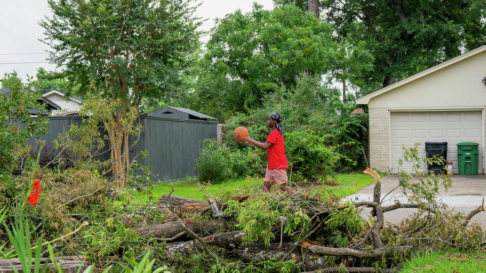 Daeveyian Gold, 13, a 7th grade student at Cunningham Middle School in Galena Park Independent School District, walks down his street in northeast Houston, TX on Tuesday May 21, 2024. Gold had not returned to school since the powerful storms that swept through the Houston region last Thursday.