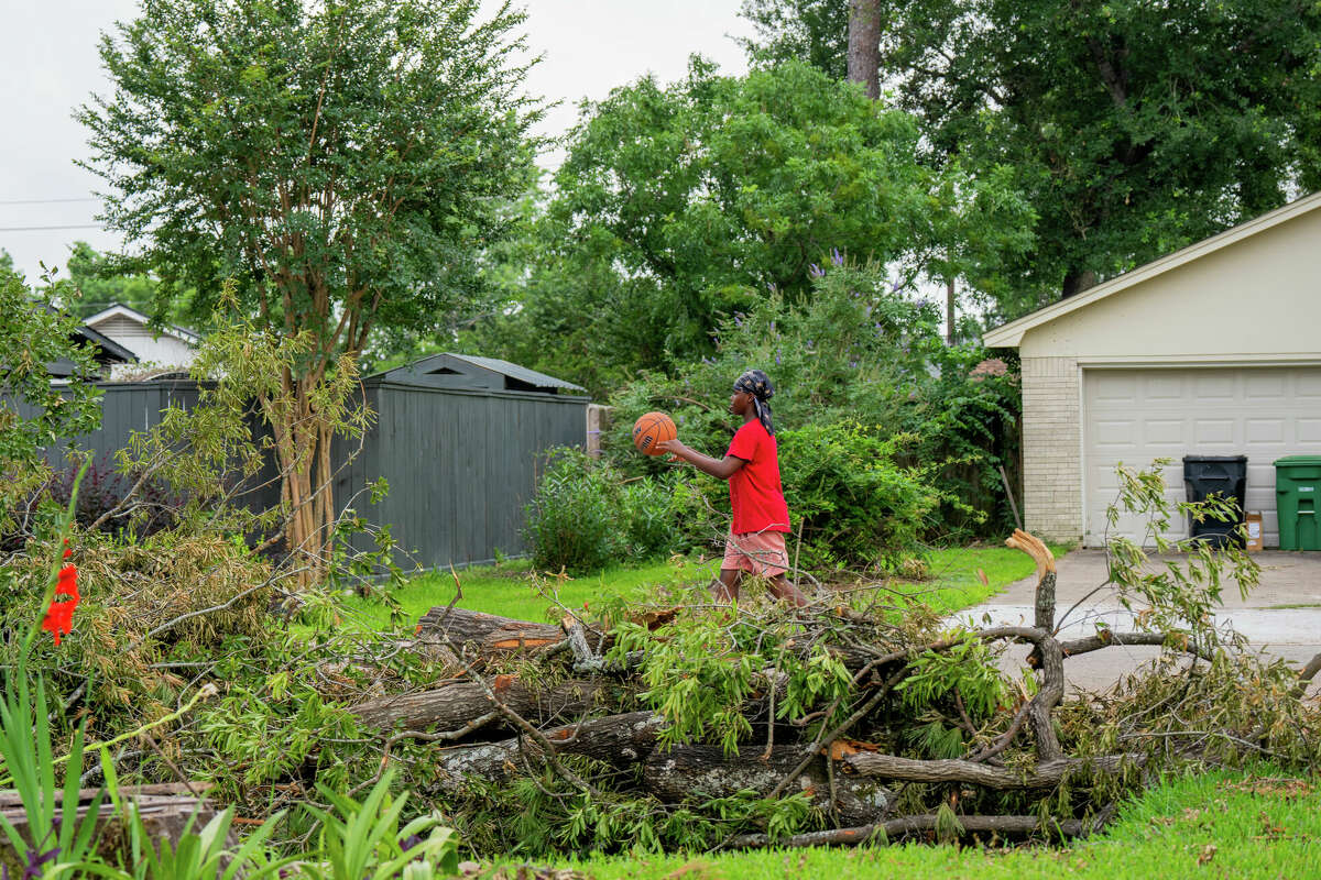 Daeveyian Gold, 13, a 7th grade student at Cunningham Middle School in Galena Park Independent School District, walks down his street in northeast Houston, TX on Tuesday May 21, 2024. Gold had not returned to school since the powerful storms that swept through the Houston region last Thursday.