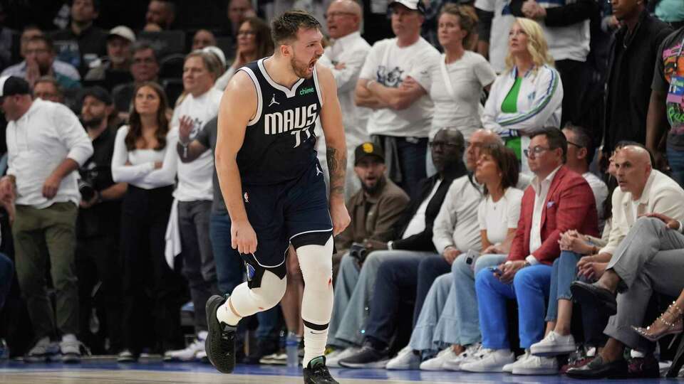 Dallas Mavericks guard Luka Doncic (77) celebrates a score against the Minnesota Timberwolves during the second half in Game 1 of the NBA basketball Western Conference finals, Wednesday, May 22, 2024, in Minneapolis.