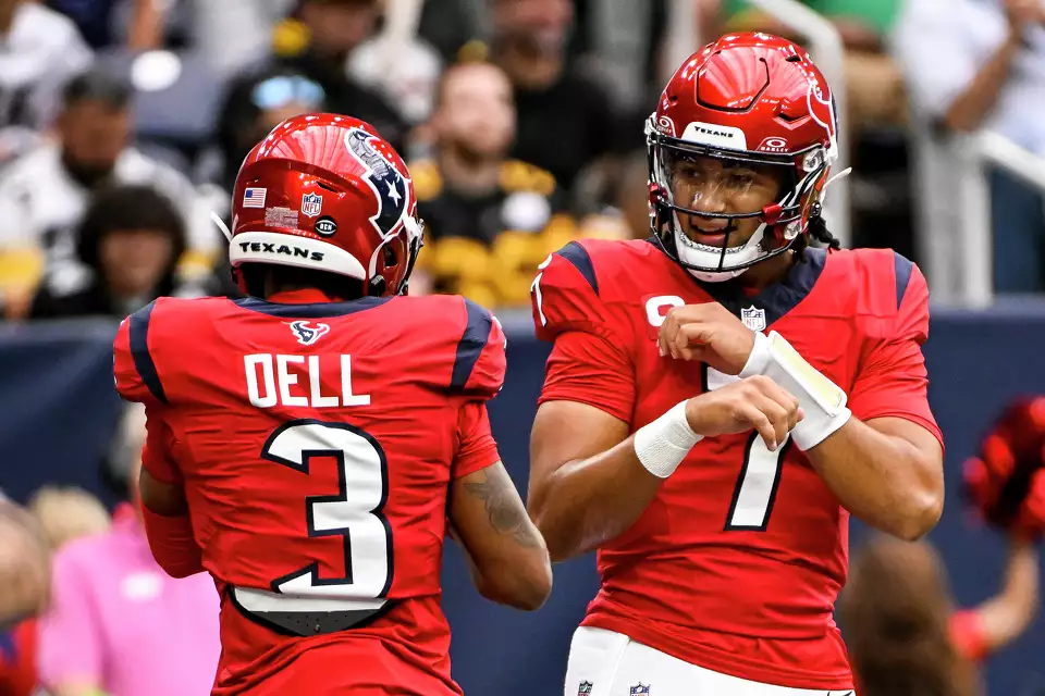 C.J. Stroud #7 celebrates with Tank Dell #3 of the Houston Texans after defeating the Pittsburgh Steelers at NRG Stadium on October 01, 2023 in Houston, Texas.u00a0