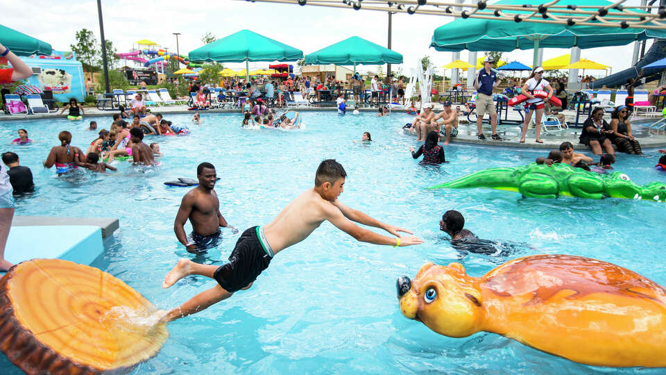 Kids play on a ropes course over the water at Typhoon Texas water park on Saturday, May 28, 2016, in Katy. ( Brett Coomer / Houston Chronicle )