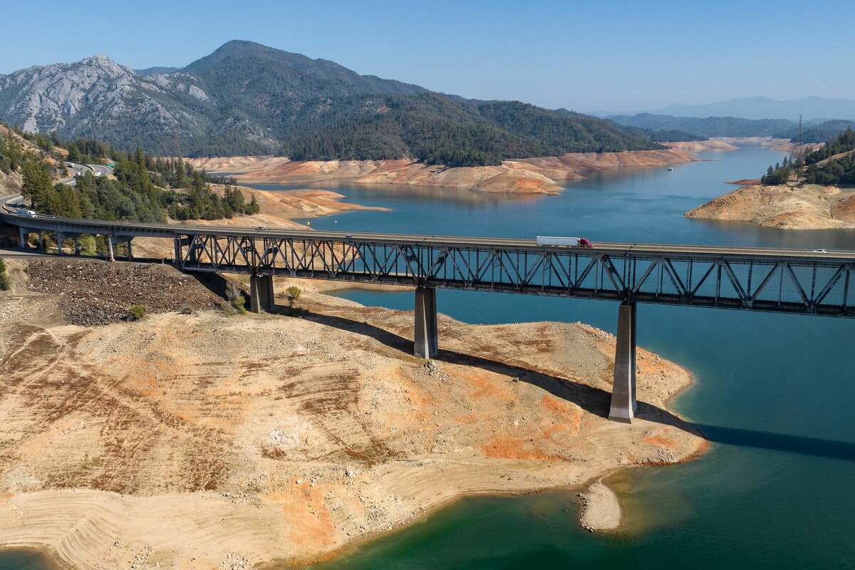 The Pit River Bridge stretches over a drying section of Shasta Lake in Lakehead, California on October 16, 2022. Shasta Lake was at 32% of its capacity.