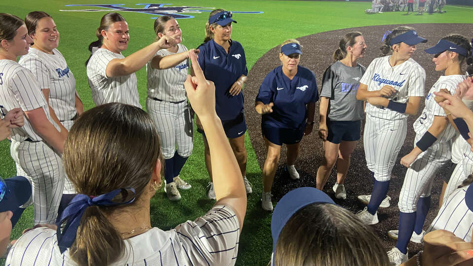 Kingwood coaches and players signal '1' for one win away from the state softball tournament following a walk-off 6-3 Game 1 win in their regional final series against Katy on Thursday at Kingwood High School.