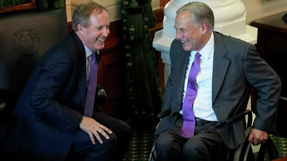 FILE - Texas Attorney General Ken Paxton, left, and Gov. Greg Abbott talk during on the first day of the 88th Texas Legislative Session in Austin, Texas, Jan. 10, 2023. Abbott and Paxton are looking to settle political scores within their own party in the Tuesday, May 27, 2024, primary runoff elections. Abbott is focusing on GOP members who helped defeat his 2023 education plan. Paxton has targeted more than 30 incumbents who voted to impeach him last year on corruption charges.