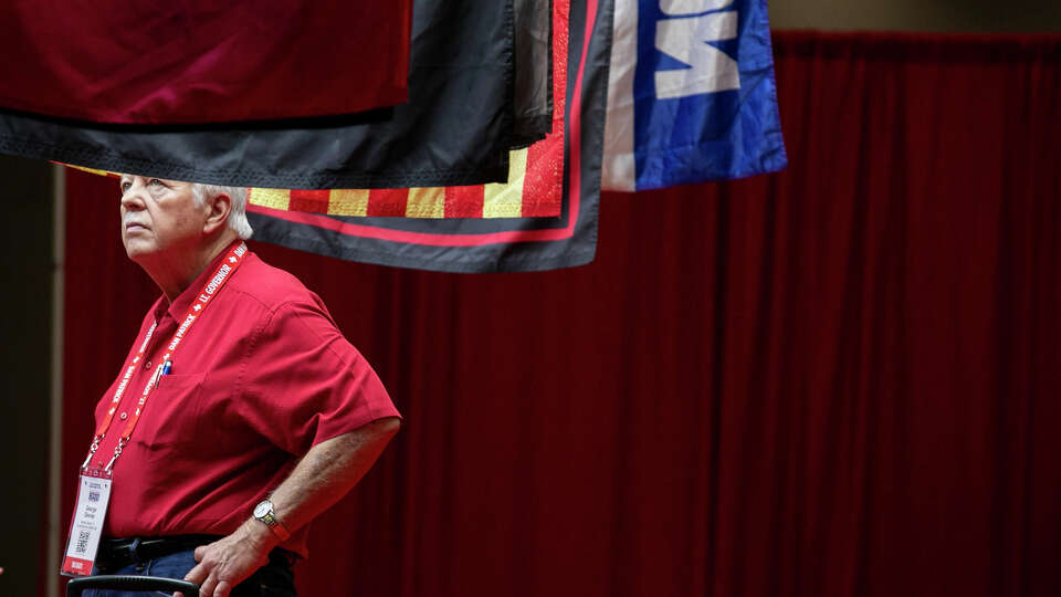 George Devine looks at flags for sale during the Texas GOP convention at Henry B. Gonzalez Convention Center on Friday, May 24, 2024, in San Antonio, Texas.