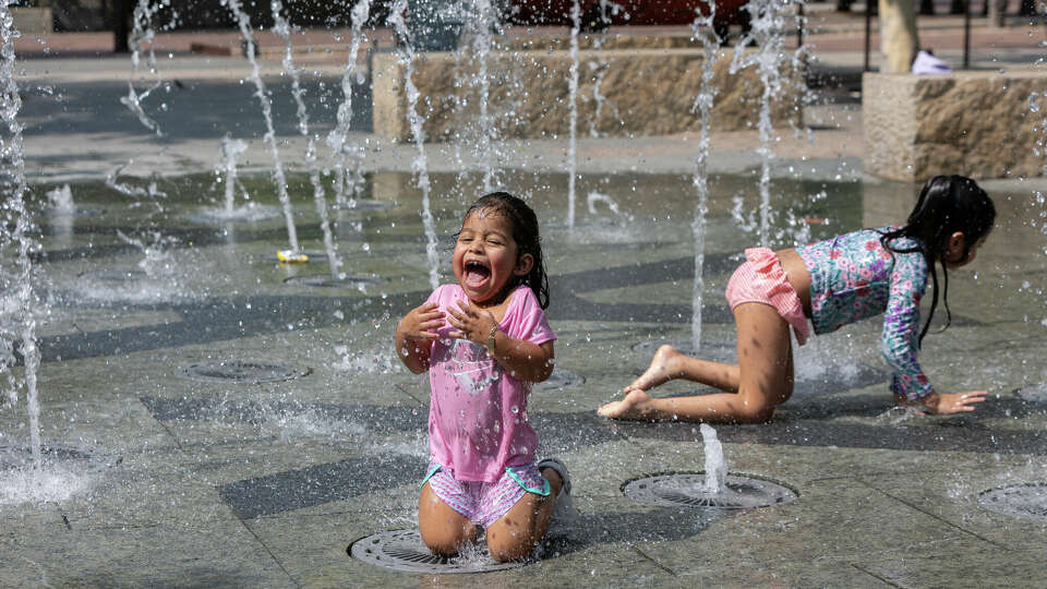 Elizabeth Renteria, 2, plays in the splash pad at the Pearl in hot weather on Tuesday, May 21, 2024 in San Antonio.